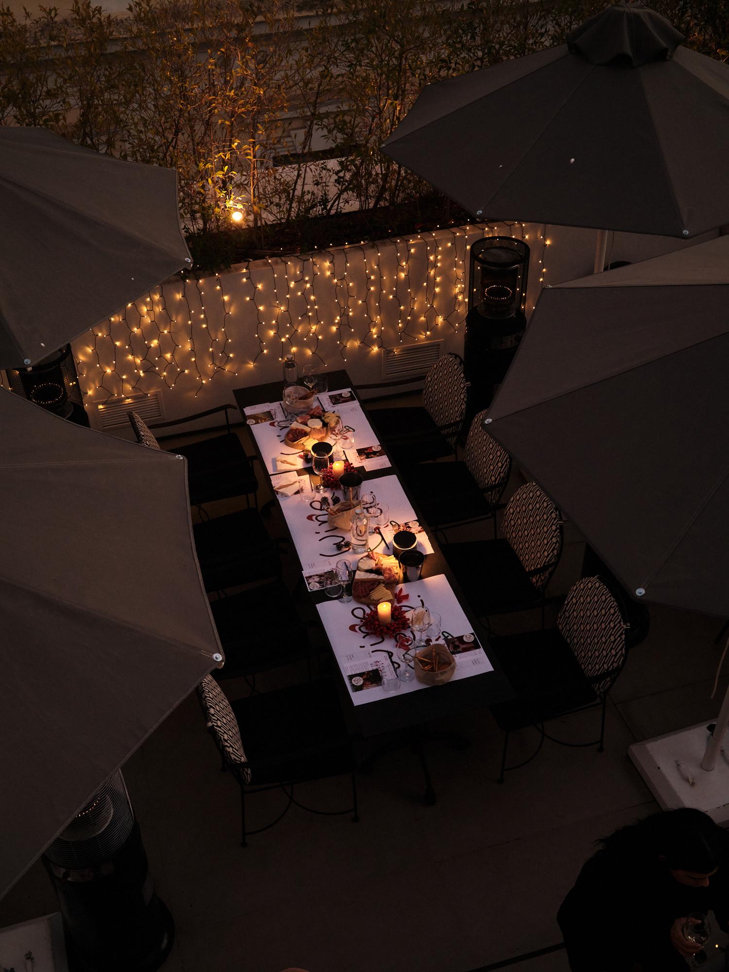 Rooftop dinner under fairy lights